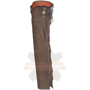 May include: Brown leather chaps with fringe detailing. The chaps feature a brown suede-like texture, a brown leather belt, and blue accents. Silver-coloured buttons and rivets add a decorative touch to the western-style garment.