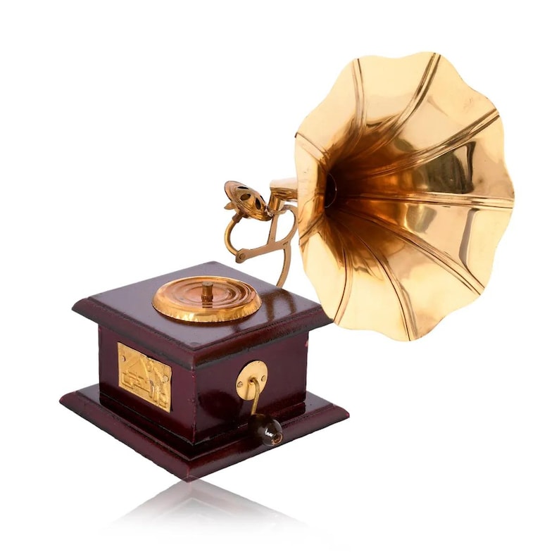 May include: A vintage-style gramophone with a polished brass horn and a dark wooden base. The gramophone features a crank handle and a gold-colored disc player. The design is reminiscent of antique audio equipment.