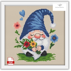 May include: A cross-stitch pattern featuring a blue gnome holding a bouquet of flowers. The gnome has a white beard and a red nose. The flowers are red, yellow, and blue. The background is a light beige.