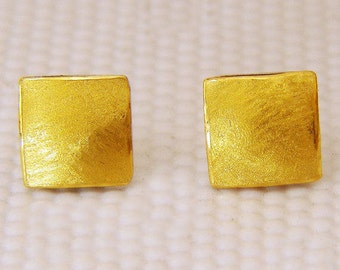 Gold puff earrings.