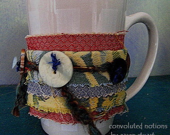 handmade fabric coffee cup cozy wrist cuff bracelet with vintage buttons and upcycled fabric remnants by convoluted notions