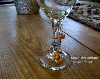 beaded wine glass charm with repurposed vintage earring in beige brown and festive colorful glass beads