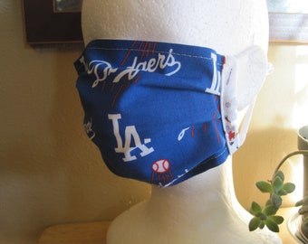 LA Dodgers face mask. World Series Champs. Baseball. MLB. Blue with red and white logos. Lined with sports print. White loops.