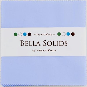 May include: A stack of square light blue fabric pieces with pinked edges, secured by a white paper band. The band features the text "moda BELLA SOLIDS by moda" in black, accompanied by a row of small green, white, blue, and brown circles.