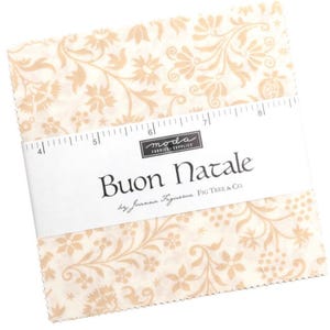 May include: A stack of fabric squares with a cream background and a beige floral pattern. The squares are wrapped with a white label that reads "Buon Natale" and "moda fabrics supplies". The fabric is by Joanna Figueroa, Fig Tree & Co.