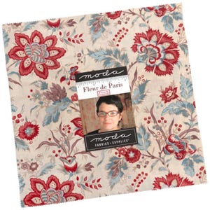 May include: Square fabric piece with a floral pattern in red, blue, and beige. The design features large flowers and smaller floral elements. A tag with the text "Fleur de Paris" and a photo is attached.