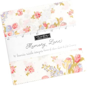 May include: A stack of fabric squares with a floral pattern in pink, yellow, and blue on a white background. The fabric is labeled "Memory Lane" by Brenda Riddle Designs. A ruler is printed on the fabric.