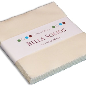 May include: A stack of square, off-white fabric pieces with pinked edges, secured by a white paper band. The band features the text "moda BELLA SOLIDS by moda" in brown and script font, accompanied by small green, white, blue, and brown circles.