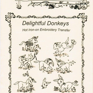 May include: Black and white line art illustration of eight adorable donkeys with flowers and a banner that reads "Delightful Donkeys Hot Iron-on Embroidery Transfer". Each transfer is good for multiple stampings.