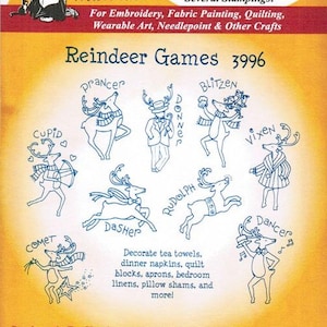 May include: A sheet of iron-on transfers featuring nine reindeer designs for crafts. The designs include Cupid, Prancer, Donner, Blitzen, Vixen, Rudolph, Dasher, Comet, and Dancer. The text "Reindeer Games 3996" is printed at the top of the sheet.