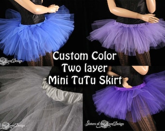 May include: A collage of images showcasing two-layer mini tutu skirts in various colors, including blue, purple, and white. The skirts have a layered, fluffy appearance. Text on the image reads "Custom Color Two layer Mini TuTu Skirt."