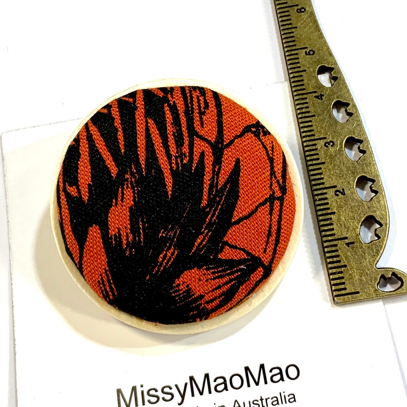 Fabric brooch large with wooden base featuring handprinted fabric.