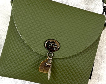 Green vegan bag in honeycomb quilt faux leather with feather, tree and star twist lock.