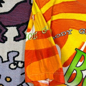 May include: Orange and yellow striped t-shirt with the text "BODY GLOW" in a green and white font. The sleeve has the text "BODY GLOW" in a green and white font. The shirt is made of a soft, comfortable material.