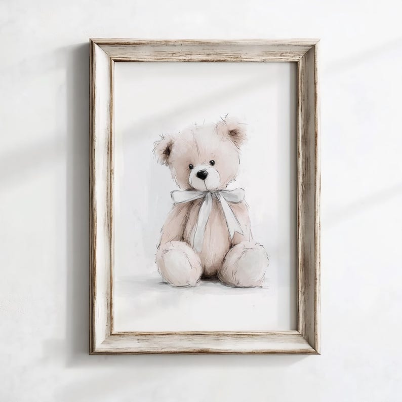 May include: A framed print showing a watercolour illustration of a teddy bear. The bear is light brown with a white bow. The frame is light, distressed wood. The artwork is set against a white background.