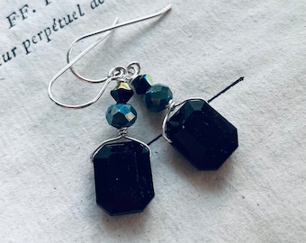 May include: Black gemstone earrings with silver hooks and green and gold beads.