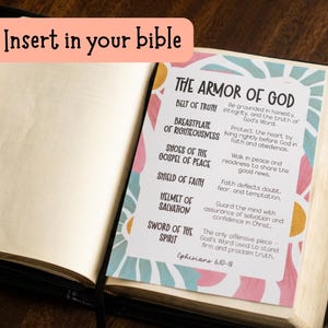 May include: Open Bible with a colorful insert titled "The Armor of God." The insert lists the elements of the armor with corresponding descriptions. The text "Insert in your bible" is in a pink bubble at the top.
