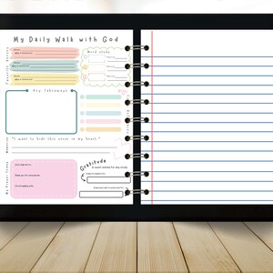 May include: A digital planner with the text "My Daily Walk with God" at the top. The planner has sections for favorite verses, key takeaways, and gratitude. The pages are lined with blue lines and have a spiral binding.
