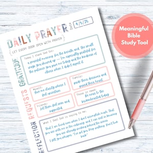 May include: A Daily Prayer journal with sections for gratitude, requests, and reflection. The journal includes prompts and space for writing, with the date 4/5/25 visible. A pink pen rests on the page, and a coral circle reads "Meaningful Bible Study Tool."