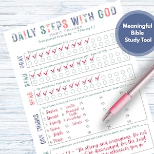 May include: A white habit tracker titled "Daily Steps With God" with check boxes and a pink pen. The tracker includes sections for prayer, reading, and giving thanks, with Bible verses. A blue circle reads "Meaningful Bible Study Tool".
