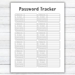 May include: A white Password Tracker sheet with a grid layout. The title "Password Tracker" is at the top. Each section has fields for Website, E-mail, Username, and Password. The sheet is on a white wooden surface.
