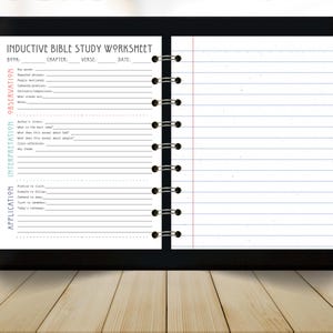 May include: A black tablet displaying an "Inductive Bible Study Worksheet" with lined pages and a spiral binding. The worksheet includes sections for observation, interpretation, and application, with prompts for notes and key insights. The tablet rests on a light wood surface.