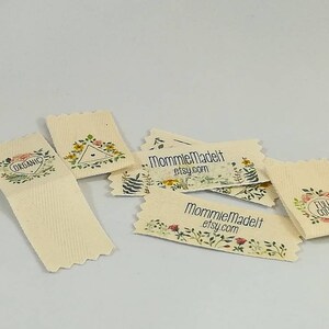 May include: A set of six small, rectangular, cream-colored fabric labels with floral designs and text. The labels feature the text "Organic", "Full Color", and "MommieMadeIt etsy.com".
