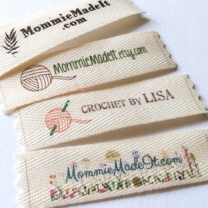 May include: Four off-white fabric labels with embroidered text and graphics. The labels feature the text "MommieMadeIt.com", "MommieMadeIt.etsy.com", "CROCHET by LISA", and "MommieMadeIt.com". Each label has a unique design, including a leaf, yarn ball, and floral elements.