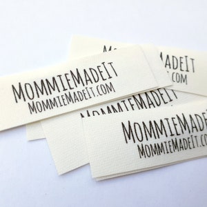 May include: A stack of white rectangular labels with the text "MommieMadeIt MommieMadeIt.com" printed in black.