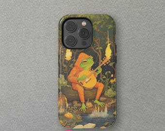 May include: A green frog wearing an orange hooded robe plays a guitar in a forest setting. The frog is sitting on a rock with a stream of water flowing in front of it. The background is a dark green forest with glowing lights.