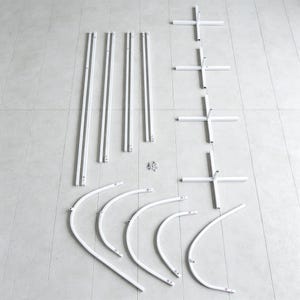 May include: A set of white metal components for an assembly kit, including four long straight poles, four cross-shaped base stands, five curved arch segments, and a small collection of metal screws and fasteners arranged on a flat surface.