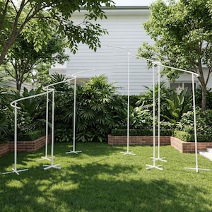 May include: A white metal backdrop stand featuring a series of interconnected vertical poles and curved horizontal bars. The structure is supported by multiple cross-shaped bases, creating a tiered, wave-like frame for event displays and decorations.