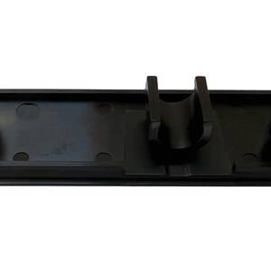 May include: Black plastic vacuum cleaner attachment holder with two round openings and a centre clip.