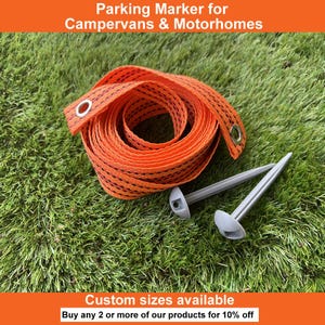 May include: An orange parking marker for campervans and motorhomes. The marker is a coiled, woven strap with black accents and metal eyelets. Two grey stakes are included. Text on the image reads: "Parking Marker for Campervans & Motorhomes" and "Custom sizes available."