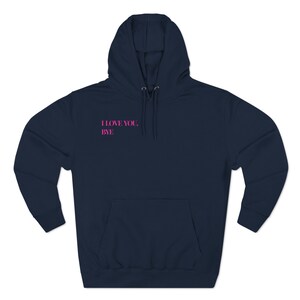 May include: Navy blue hoodie with a front pocket and a drawstring hood. The text "I LOVE YOU, BYE" is printed in pink on the upper left chest area of the hoodie.