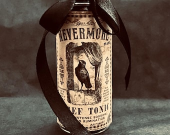 May include: A clear glass bottle with a cork stopper, tied with a black satin ribbon. The label features the text NEVERMORE BRAND, an illustration of a raven, and the words EF TONIC INTENSE SORROW AND RUMINATION BALTIMORE in black ink.