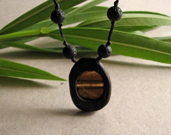 Organic Natural Tiger Eye Gem Encapsulated In Ebony Wood Hand Carved Pendant With Natural Lava Beads by Tanja Sova