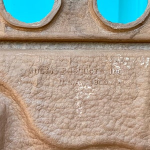 May include: Close-up of a brown textured surface with the text "MULTI PRODUCTS INC. U.S.A. 1300" embossed on it.