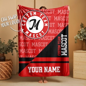 May include: Red fleece blanket with a custom team mascot design. The blanket features a large circular logo with the letter "M" and the words "Custom Team Mascot". The bottom corner has the text "Your Name".