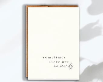 May include: A white greeting card with a brown envelope tucked behind it. The card features the black printed text "sometimes there are no words" in a combination of serif and script fonts centered toward the bottom of the card front.