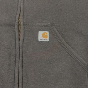 May include: A gray zip-up hoodie with a Carhartt logo patch on the left chest.