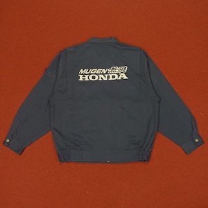 May include: A dark blue work jacket with a white embroidered logo that says "MUGEN HONDA" with a Japanese character above the word "MUGEN".