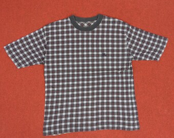 May include: A black and white plaid short-sleeved t-shirt with a small logo on the left chest.