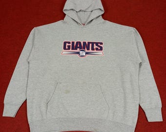 May include: Gray hooded sweatshirt with the New York Giants logo in red, blue, and white. The logo says "Giants" with "NY" in a circle underneath.