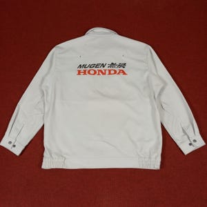 May include: White long-sleeve work shirt with a red and black "MUGEN 無限 HONDA" logo on the back.