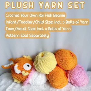 May include: A set of plush yarn in orange, yellow, white, and pink colors. The yarn is arranged in a pile with a crocheted koi fish beanie in the center. The text on the image reads "PLUSH YARN SET Crochet Your Own Koi Fish Beanie Infant/Toddler/Child Size: Incl. 5 Balls of Yarn Teen/Adult Size: Incl. 6 Balls of Yarn Pattern Sold Separately"
