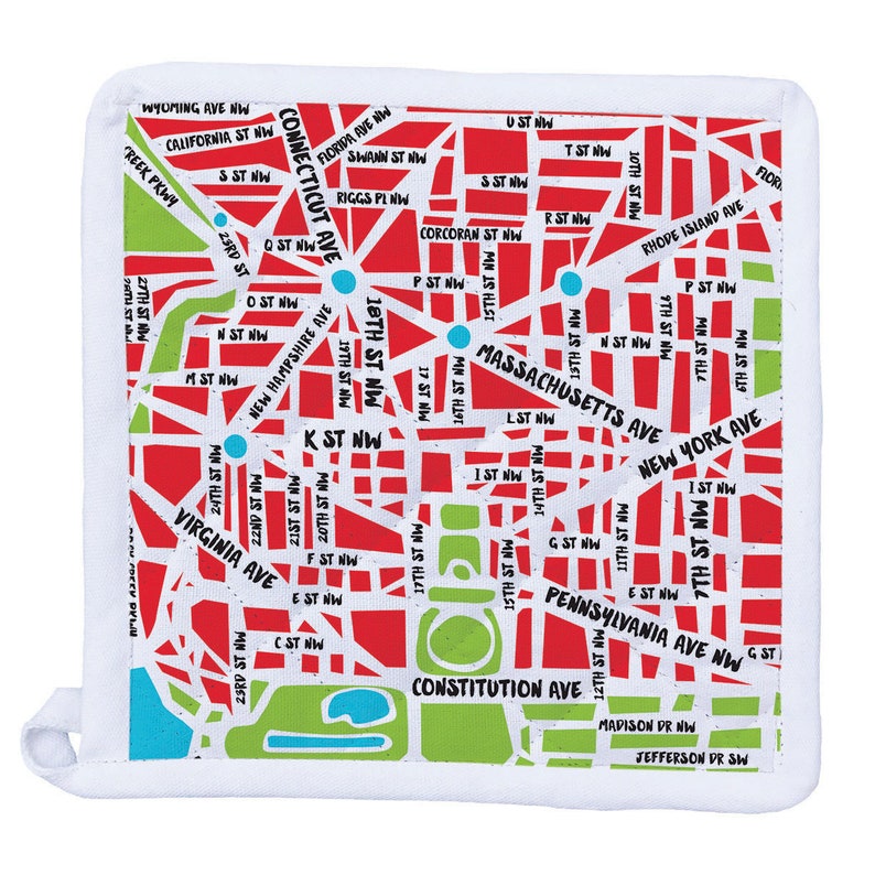 May include: A white square pot holder with a map of Washington, D.C. The design features red streets, green parks, and blue circles. Street names are printed in white. The pot holder has a loop.