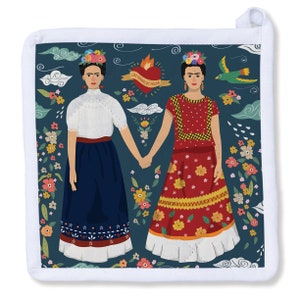 May include: Square white pot holder with a dark teal background featuring a Frida Kahlo-inspired design. Two women in traditional dresses hold hands, surrounded by flowers, clouds, and a heart with text. A green bird is also present.