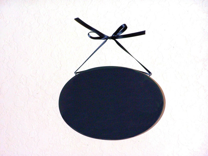 Solid wood oval shape sign with painted front, stained sides and back. 16 color choices. Measures approx. 8 inches by 5.5 inches. Black or white text saying

Your choice one or two words

Includes elegant scroll and choice hanger style.