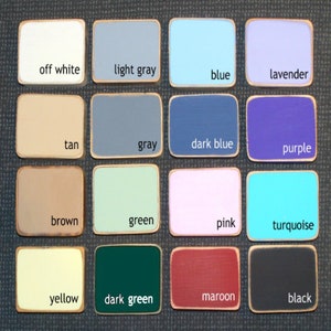 May include: A color chart with 16 different paint colors, including off white, light gray, blue, lavender, tan, gray, dark blue, purple, brown, green, pink, turquoise, yellow, dark green, maroon, and black.